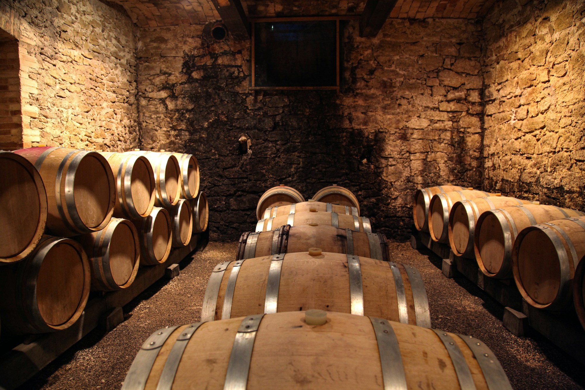 Stone wine cellar with oak barrels