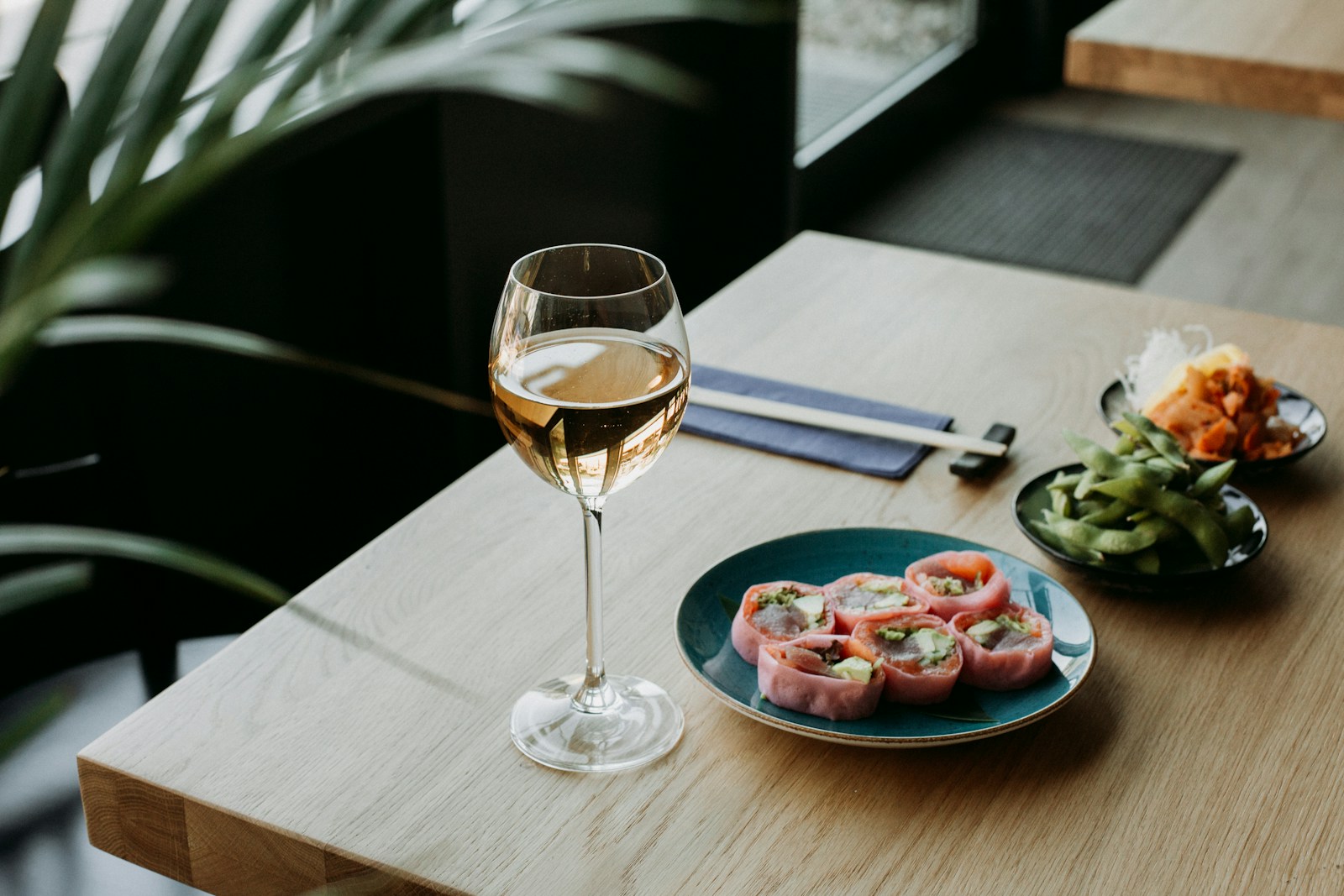 A wine glass and bread setting on a table
